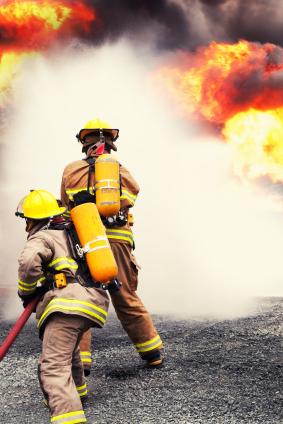 Fire fighters extinguish flames--iStock_000017175324XSmall.jpg